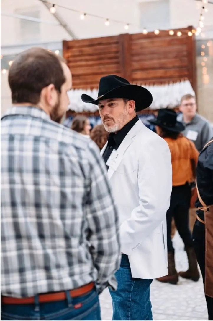 Stephen Smith speaking with a colleague at an event